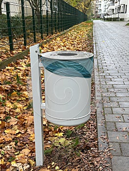 trash can with plastic bag on the street