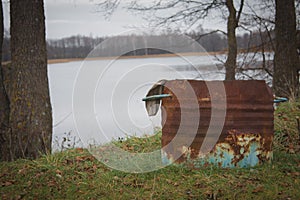 Trash can on the river bank