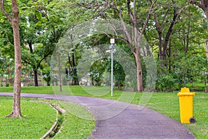 trash cans in the park beside the walk way
