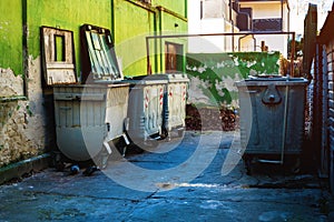 Trash container dumpsters in dirty alley