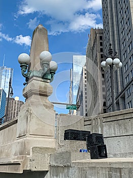 Trash of crates and empty plastic bottle discarded on the ledge opposite the sidewalk on upper Wacker Drive