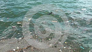 Trash and garbage floating on the surface of the water. Water pollution with dirty and plastic garbage floating on the sea