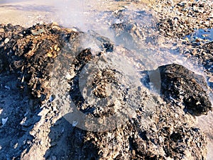 Trash heap burnt ashes waste pile on fire garbage smoke rubbish burning ashes air pollution dump litter image photo photo
