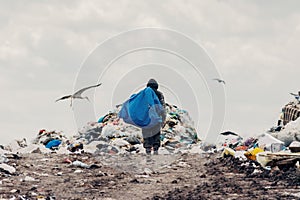 Trash keeper on Landfill. People find or searching garbage for sell to reuse and recycle in landfill