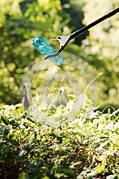 Trash picker with plastic bottle