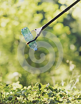 Trash picker with plastic bottle