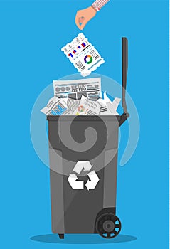 Trash recycle bin container full of paper