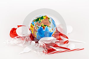 Trash scattered around globe on white