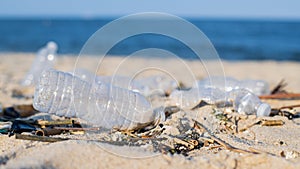 Trash and used plastic bottles on the beach. Environmental pollution. Ecological problem