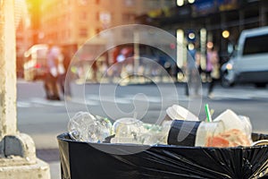 Trash waste bin on new york city street with people