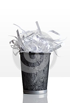 Trashcan full of shredded paper