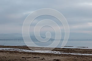 Trasimeno lake shore at dawn with low light and muted colors