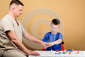 Trauma and injurie. Medicine concept. Kid little doctor sit table medical tools. Health care. Medical examination. Boy photo