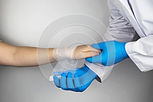 The traumatologist applies a bandage to the patient`s wrist. The concept of helping with fractures and sprains. The technique of photo
