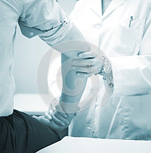 Traumatologist orthopedic surgeon doctor examining patient photo