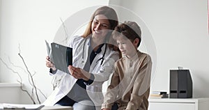 Traumatologist showing x-ray with radiology results to little boy