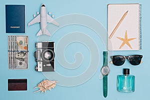 Travel accessories on blue background, travel concept. Top view with copy space