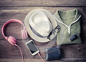 Travel accessories. Shirts, hats,smart-phone,earphone, wallets, glasses, car keys ready for the trip