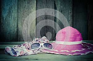 Travel accessories for young women Sombrero pink scarf sunglasses.on wood. photo