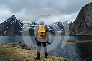 Travel and adventure background, hiker with backpack enjoying landscape in Lofoten, Norway