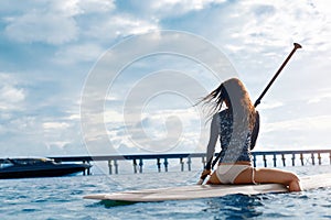 Travel Adventure. Woman Paddling On Surfing Board.