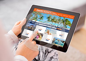 Travel agency`s website on tablet computer photo