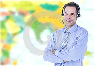 Travel agent man wearing headset in front of world map