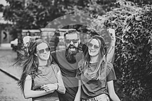 Travel around the country. Girlfriends and bearded boyfriend smile on summer vacation