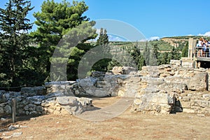 Travel around Europe by car. An ancient ruins of Greek Knossos palace and group of tourists.