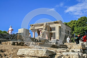 Travel around Europe by car. An ancient ruins of Greek Knossos palace and group of tourists.