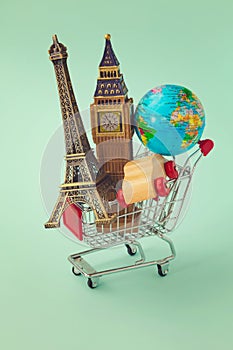 Travel around the world concept. Shopping cart with souvenir from around the world. Retro filter effect