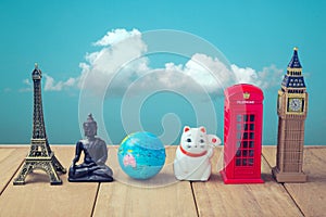 Travel around the world concept. Souvenirs from around the world on wooden table over blue sky background