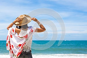 Travel asia woman with hat and dress on sea