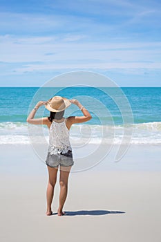 Travel asia woman with hat looking out of sea