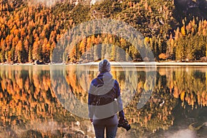 Travel in autumn outdoors, photographer traveler with backpack and dslr camera