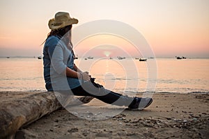 Travel background beautiful young women sit alone beach with sea