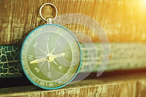 Travel background concept from closeup compass with sunlight.