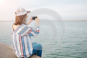 Travel background young women sit alone bridge hold mobile phone