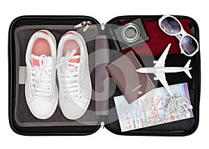 Travel bag concept, Prepare accessories and travel items on white wooden board, Open traveler`s bag with clothing, accessories, cr