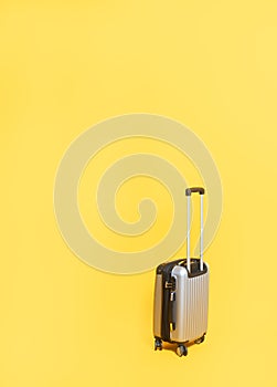 Travel bag with zipping number code locked. Silver suitcase number code lock on yellow background with copy space