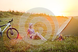 Travel with bicycle alone - young woman in the tent