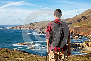 Travel in Big Sur, man Hiker with backpack enjoying view coastline pacific ocean, California, USA