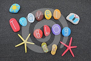 Travel Blog text with colored stones over black volcanic sand