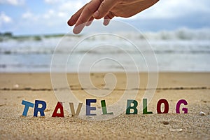 TRAVEL BLOG wood letters on the beach