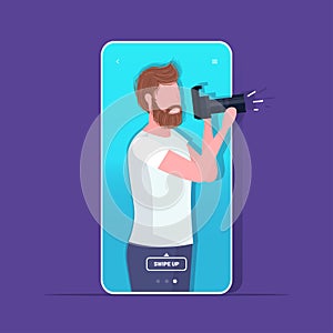 Travel blogger using digital camera man photographer taking photo blogging shooting vlog concept portrait smartphone