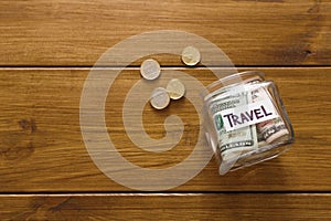 Travel budget concept. Money saved for vacation in glass jar on map