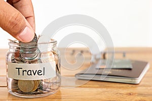 Travel budget concept. Travel money savings concept. Collecting money in the money jar for travel. Money jar with coins, aircraft.