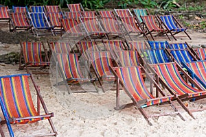 Wooden beach chairs at the beach for tourist in Thailand