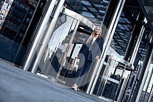 Travel, business trip. Business woman walking out of airport