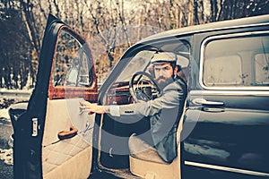 Travel and business trip or hitch hiking. Escort man or security guard. Call boy in vintage auto. Bearded man in car